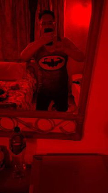DAVID DEL REAL. COSPLAYING. Batman Cosplay under RED light.