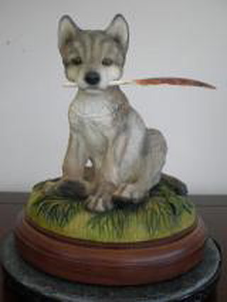 Wolf Figurine - Large Pup Sitting, Holding Feather (Misbehavin' - Mill Creek Studios)